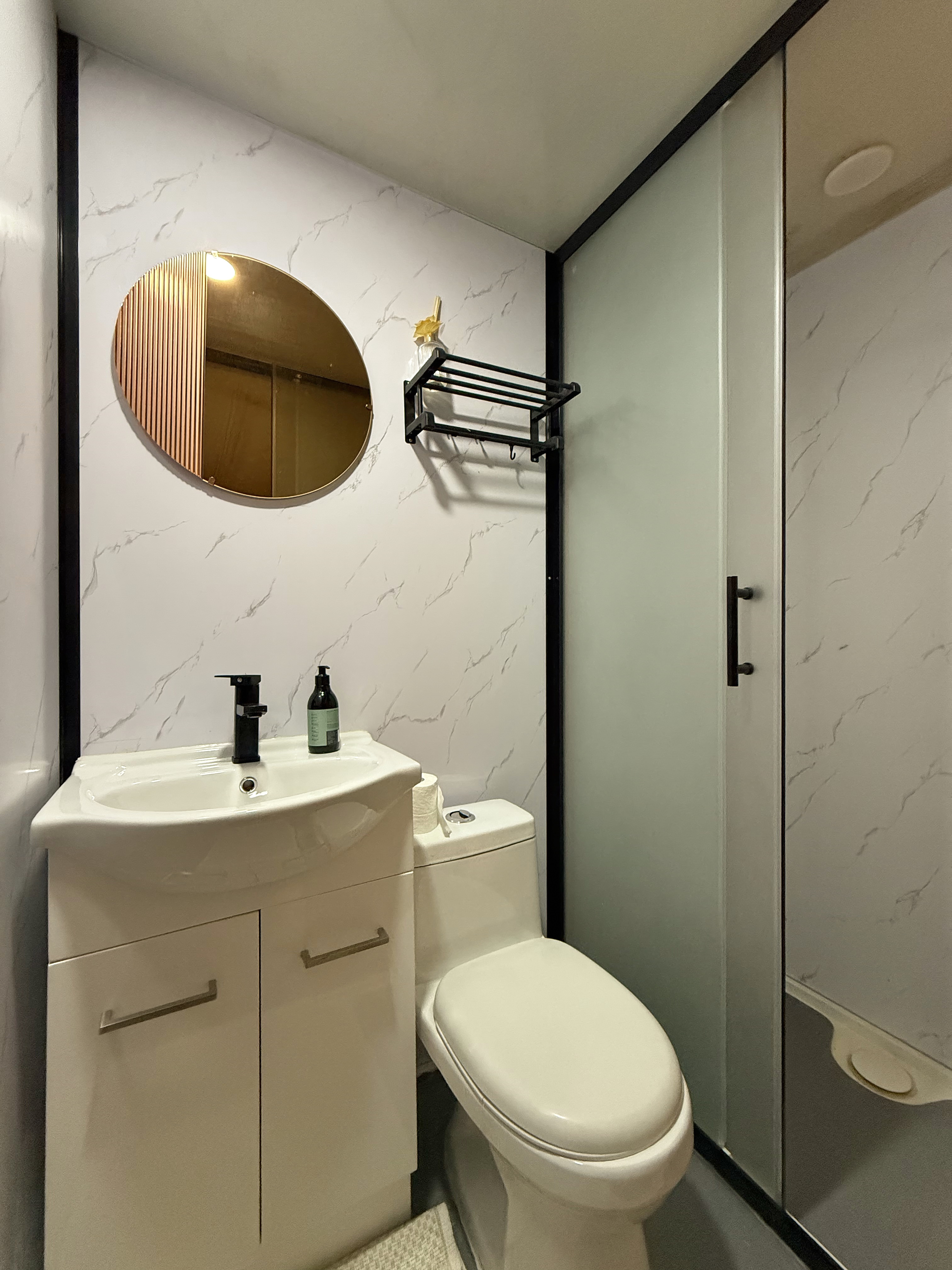 Private ensuite bathroom with vanity, toilet and shower inside luxury glamping dome